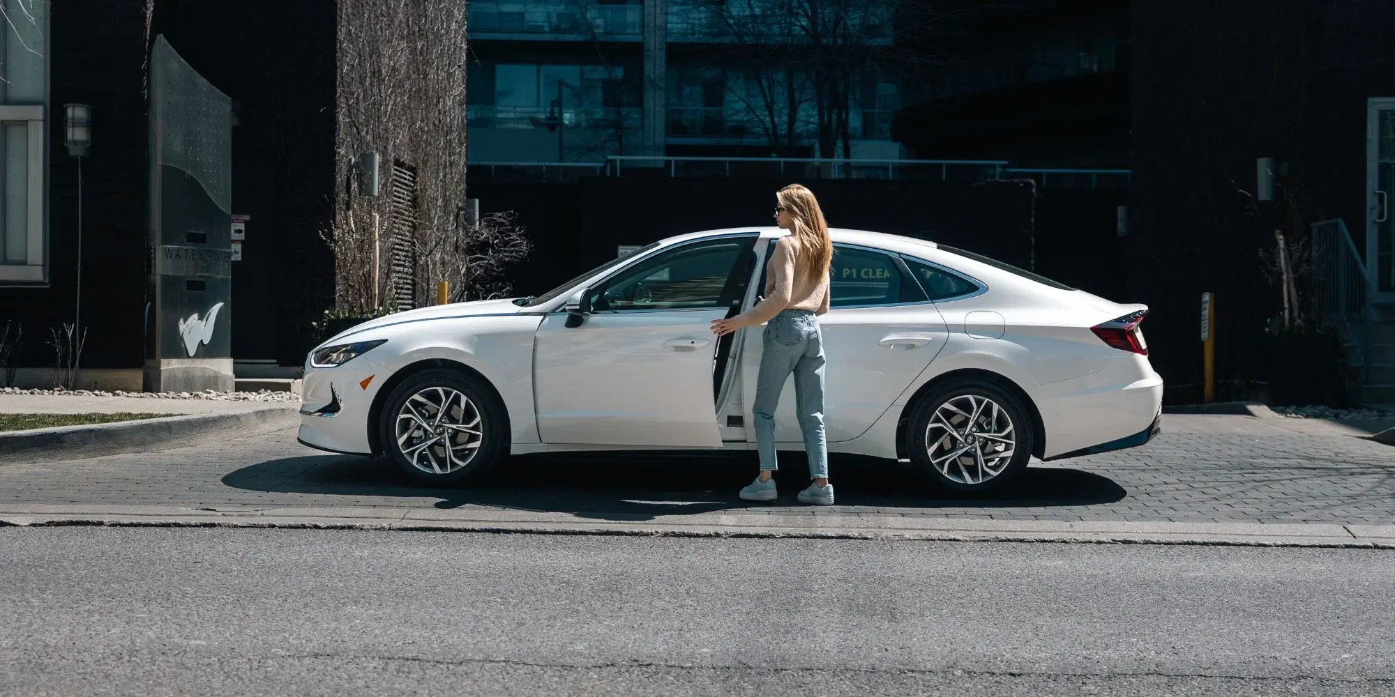 Customer approaching a Roam vehicle on a city street